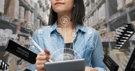 Supply chain professional walking the aisles of a storage facility with ipad in hand as she takes stock; using technology platforms is the future of procurement. Learn how Sourcengine can help you with your own process. 