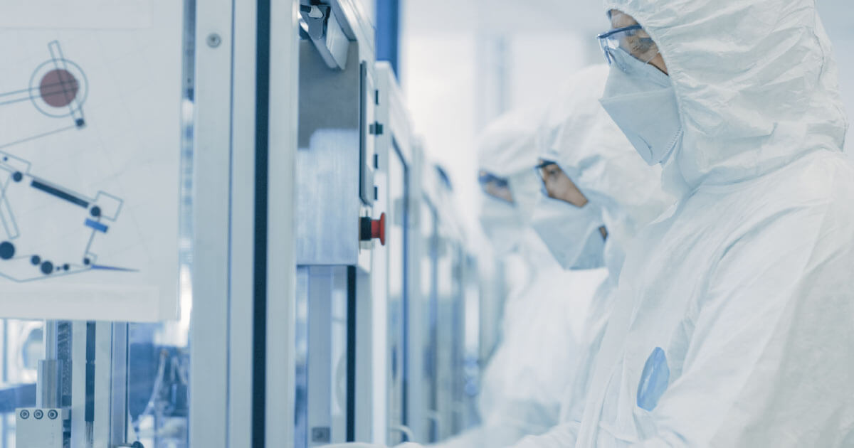 Engineer dressed in personal protective equipment while working in a component lab. Maintenance, repair, and operations equipment is a necessity to protect people during the new normal, take a look at Sourcengine's line of MRO to keep your company moving.