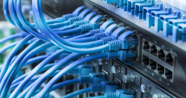 CAT cables running out of an industrial router. Teltonika's RUTX11 industrial router will help any supply chain manage its properties; find this product now at Sourcengine.