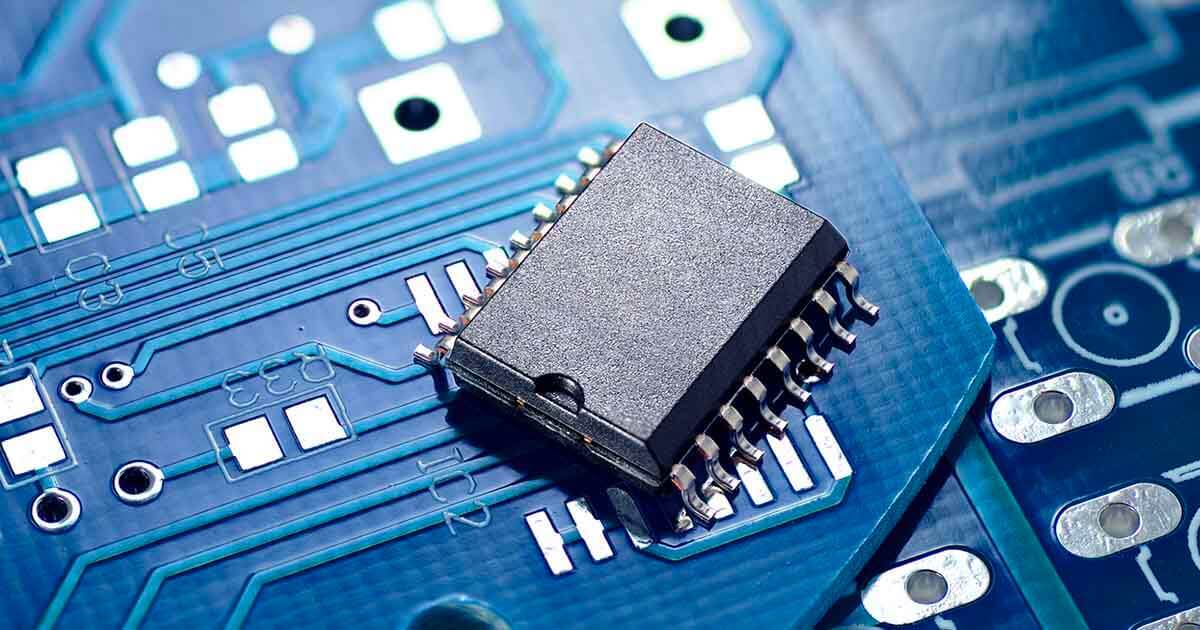 A microchip set against a prefabricated circuit board; a demand in semiconductors is leading to an industry-wide shortage and now price hikes.