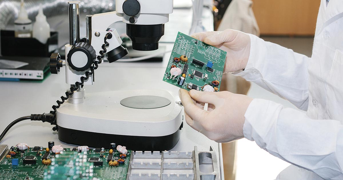 Worker examining a pcb in a lab. China is creating its own committee for the standardization of integrated circuits. For more information and other current, industry news stories, see Sourcengine.