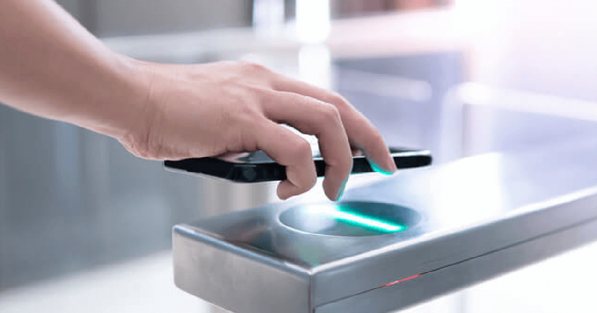 Individual using a smart phone to gain access via a touchless entry point system; for the latest electronic components industry trends in 2021, see Sourcengine.