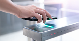 Individual using a smart phone to gain access via a touchless entry point system; for the latest electronic components industry trends in 2021, see Sourcengine.