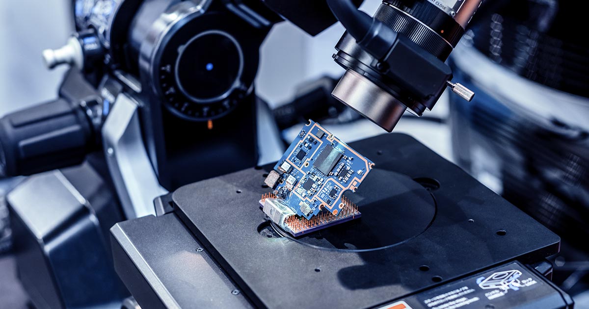 Microchip being produced under a power microscopic lens; passive and reactive component lead times have increased during the global chip shortage. Are you prepared? Try using sourcengine.com for all your sourcing needs.