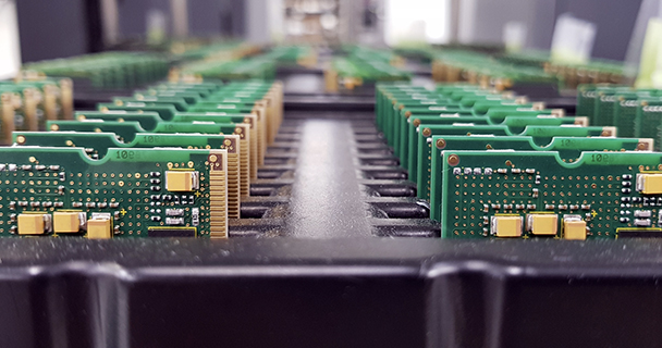 Multiple rows of assembled green printed circuit boards. | Sourcengine