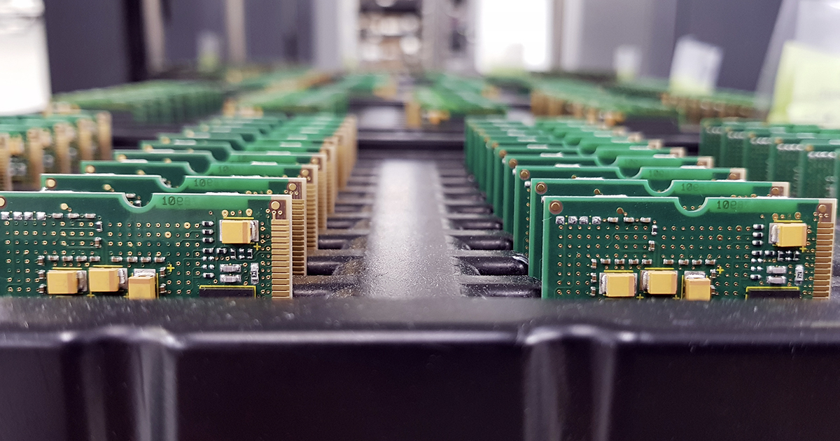 Multiple rows of assembled green printed circuit boards. | Sourcengine