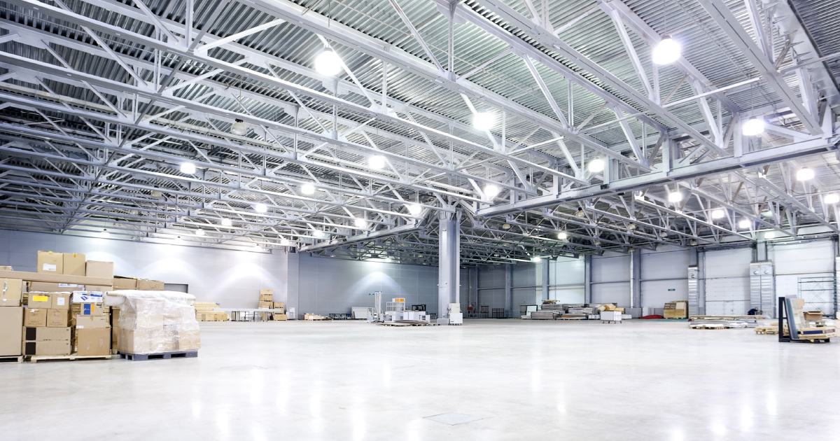 A large warehouse with an elaborate LED setup and a few scattered pallets stacked with boxes. | Sourcengine.