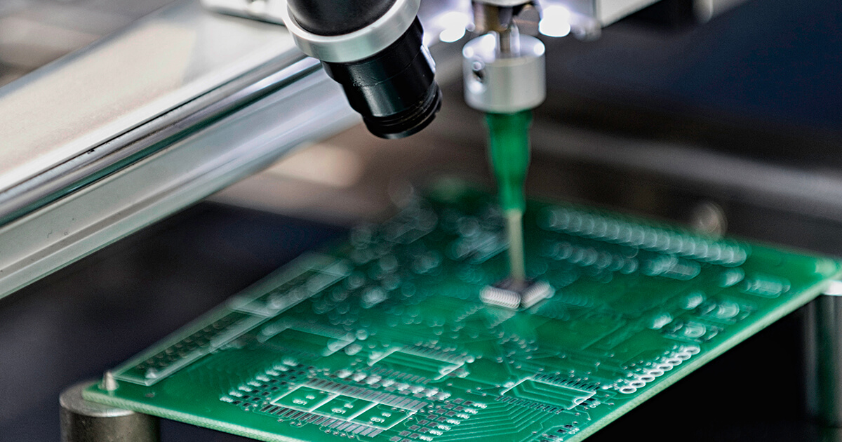 A printed circuit board undergoes automatic assembly while a digital camera observes. | Sourcengine