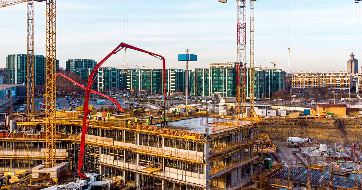 A photo of a massive active construction site in a modern city. 