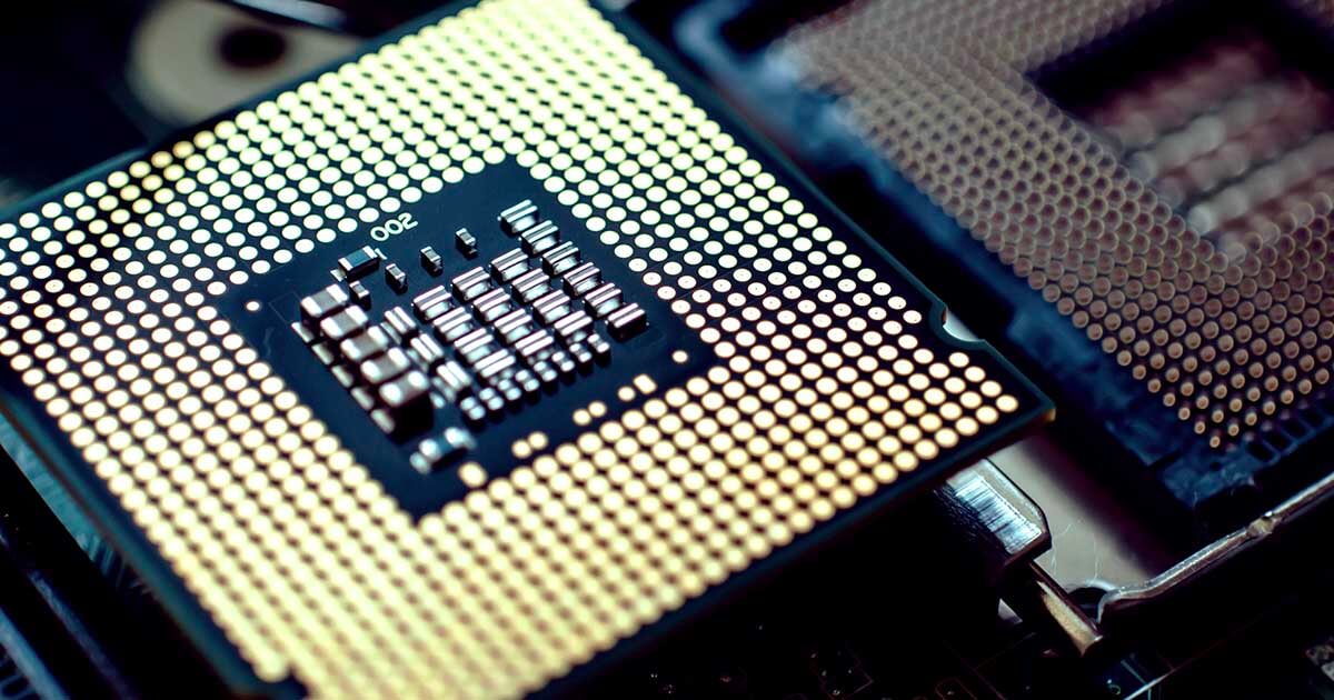 An extreme closeup of a microprocessor that sits next to another CPU.