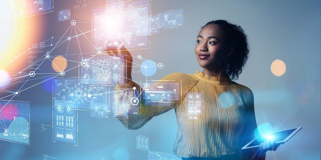 The image of a young woman holding a tablet computer while standing in front of a futuristic digital interface for an enterprise marketplace. 