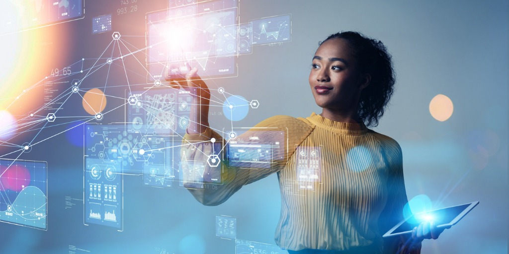 The image of a young woman holding a tablet computer while standing in front of a futuristic digital interface for an enterprise marketplace.