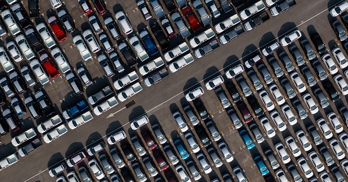 An image of an aerial view of cars parked in a parking lot