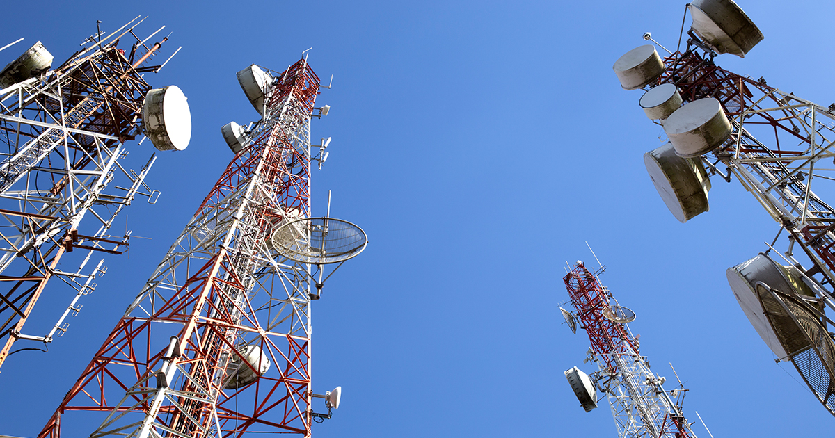 An image of a cell tower from a ground view 