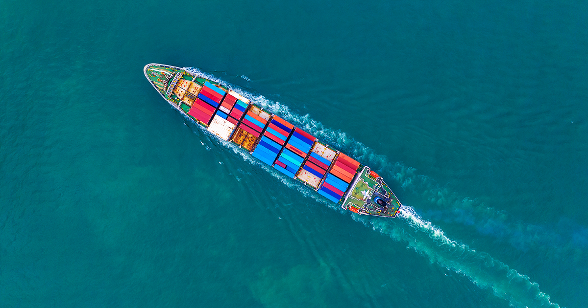 An image of a container ship traveling on the water